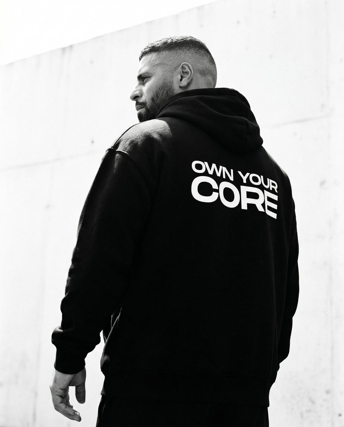 Athlete in a FUNCTNL hoodie holding a sachet